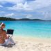 lady-in-white-w-laptop-on-beach-fotolia_6063694_subscription_l-1024×682